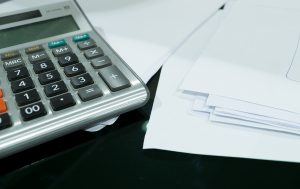 calculator next to some papers