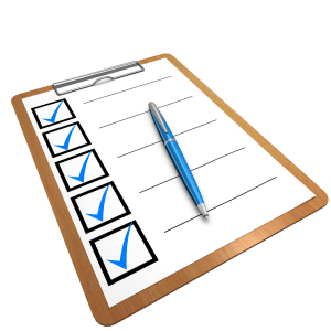 checklist with all the boxes checked and a pen on the clipboard