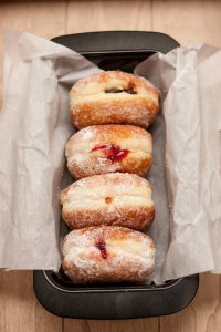 4 jelly donuts in a pan