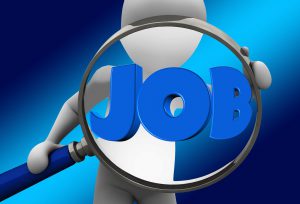 person with magnifying glass and the word job in the middle