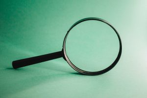 magnifying glass with a teal background