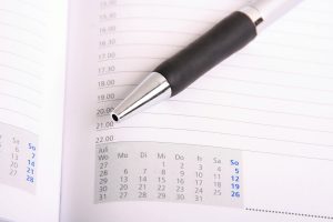 scheduler open with a pen on top of a page