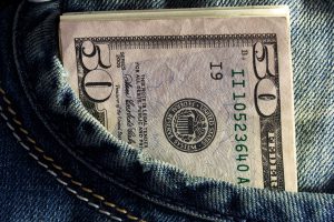 fifty dollar bill in a jean pocket.