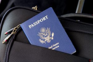 blue passport in luggage's front pocket
