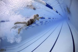 man swimming in a pool