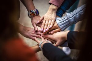 hands on top of each other in a circle