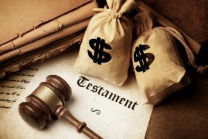 money bags with a gavel and paper wit the word testament on it
