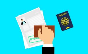 papers being stamped with approval stamp and passport next to it