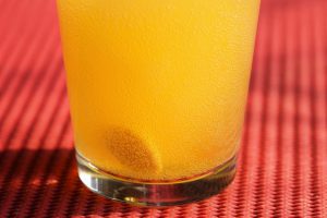 vitamin c drop fizzing in a glass cup