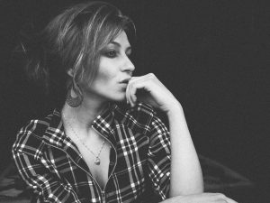 black and white picture of a woman with her hand on her chin thinking