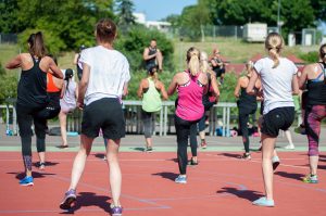 people taking an exercise class outside