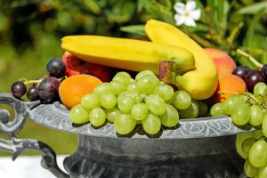 grapes, bananas, and other fruits on a plate