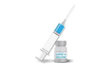 needle and vial with covid-19 vaccine on the label