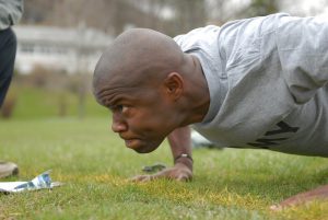 african american man doing a pushup outdoors