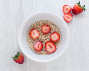 bowl of oatmeal with strawberries on top