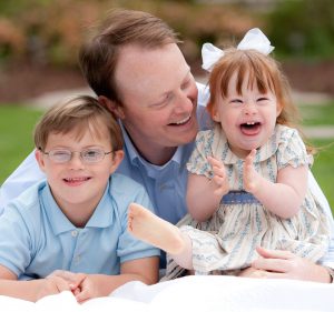 Amy's husband with Bitty and Beau smiling