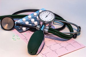 blood pressure cuff with medicine laying on top of it