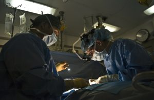 two doctors in the operating room performing surgery