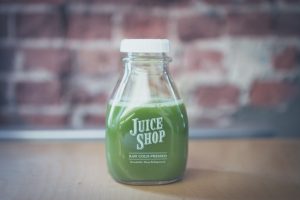 green juice in a bottle that says juice shop