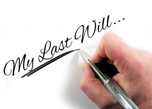 my last will written by a hand holding a pen