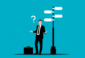 person in a suit with a question mark next to them and a sign with many directions