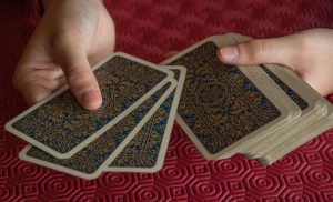 hands dealing a deck of cards