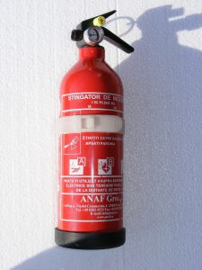 red fire extinguisher on a wall