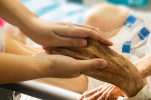 hands holding an elderly person's hand