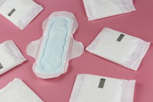 women's pad opened up with other pads in wrappers around it