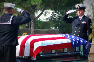 military funeral with an american flag over a casket