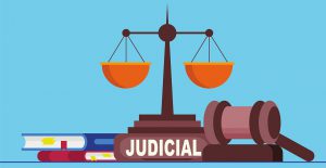 gavel with the scale and a book that says judicial underneath it