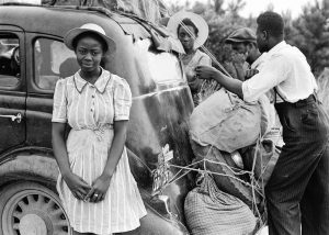 black and white picture of an African American family packing a car