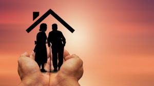 silhouette of an older couple under a house roof