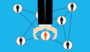 illustration of hands over a person in a network of people