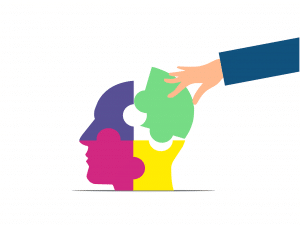 head puzzle of 4 different colors being put together by a hand