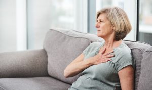 older woman grabbing her chest