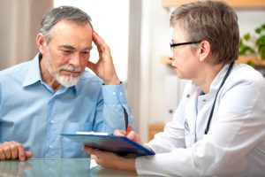 older man talking with a doctor