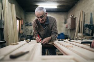 older man working with wood