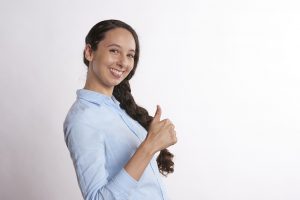 caucasian woman smiling with her thumb up