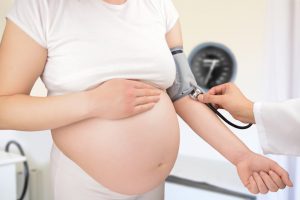 pregnant woman getting blood pressure checked