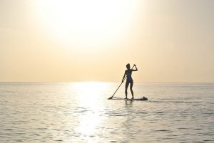 woman standing on a paddleboard in the ocean