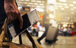 person's hand holding a boarding pass