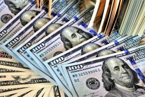 hundred dollar bills piled up 