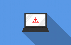 laptop screen with a caution sign on it
