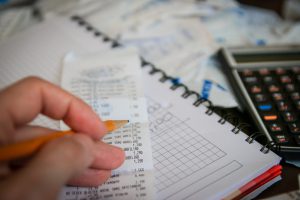 hand with a receipt and calculator