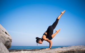 woman doing a yoga pose with her legs in the air