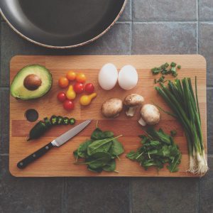 vegetables and an egg on a chopping block