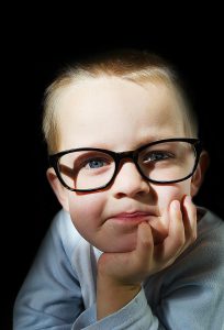 little boy in black glasses