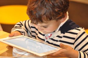 little boy looking at a tablet