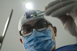 dentist with a light on his head.